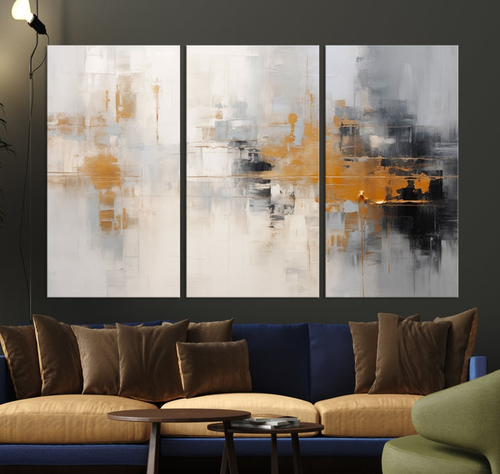 The Orange Pastel Abstract Wall Art Canvas Print, featuring a triptych of orange, white, and black hues, is elegantly displayed on museum-quality canvas.