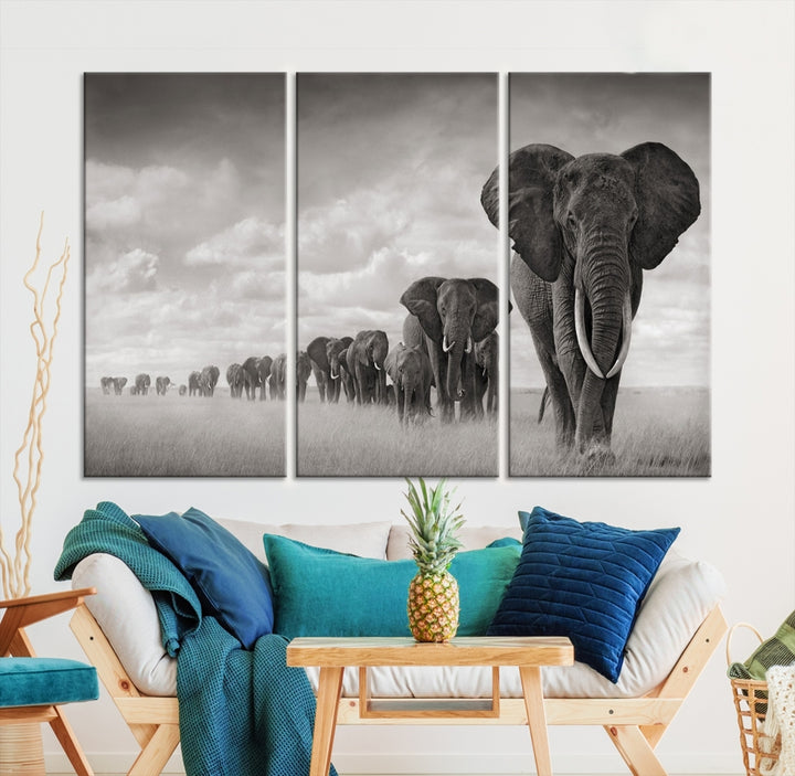 The Elephant Wall Art Canvas Print features a triptych of elephants in a savanna, elegantly displayed.