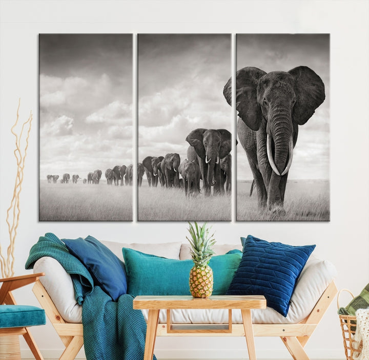 The "Herd of Elephants Wall Art Canvas Print" features an elegant black and white triptych of elephants walking in a line, beautifully displayed on museum-quality canvas with a UV-protective coating. This artwork arrives ready to hang and adds sophistication to any space.