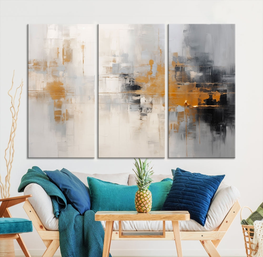 The Orange Pastel Abstract Wall Art Canvas Print, featuring a triptych of orange, white, and black hues, is elegantly displayed on museum-quality canvas.