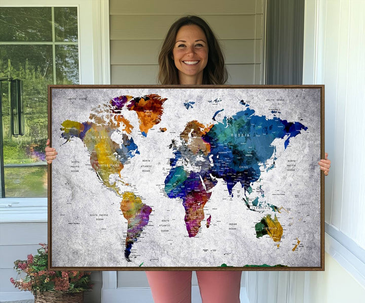 The World Map Art Canvas Print, featuring country names on a grunge-stained gray background, is perfect for stylish home decor.