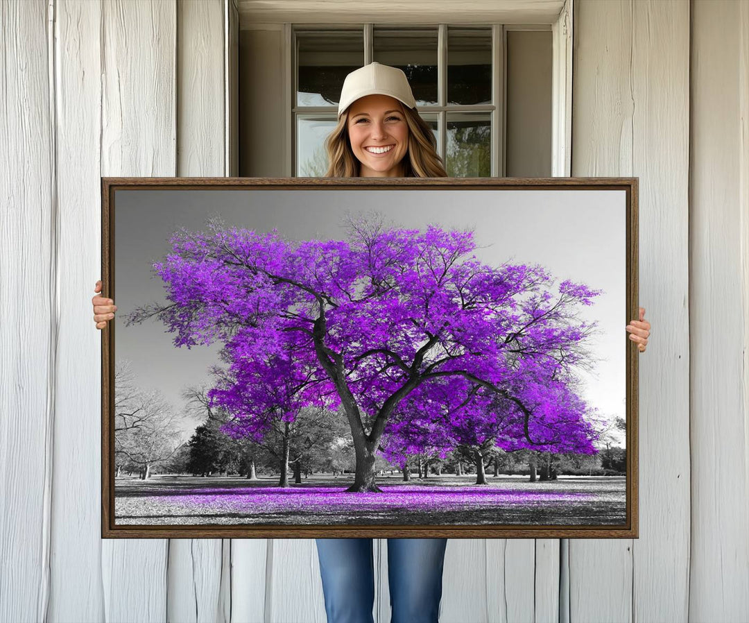 The Big Purple Tree Wall Art Canvas Print showcases a vibrant purple tree set against a black-and-white landscape.