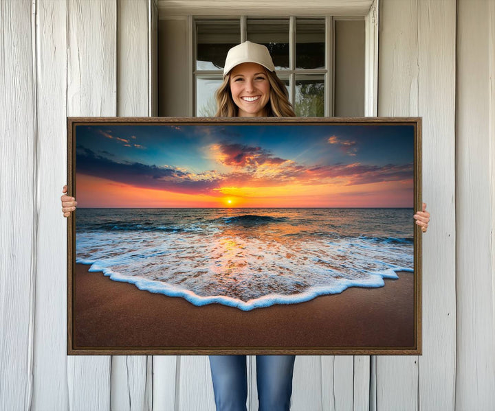 A Sunset with Calm Waves on the Beach Wall Art Canvas Print adorns the dining room.