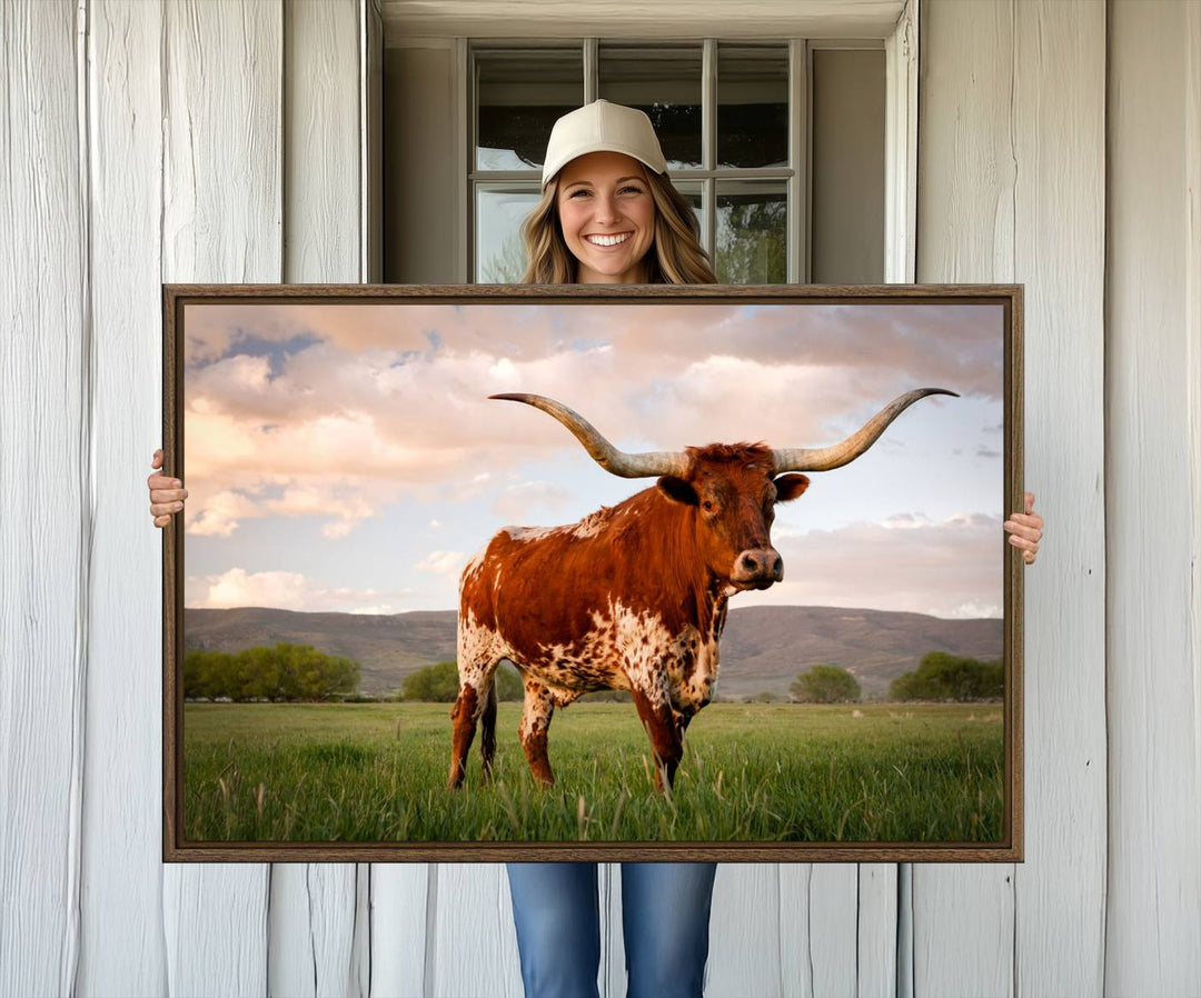 The Texas Cow Canvas Wall Art print captures a longhorn cow at sunset and is ready to hang.