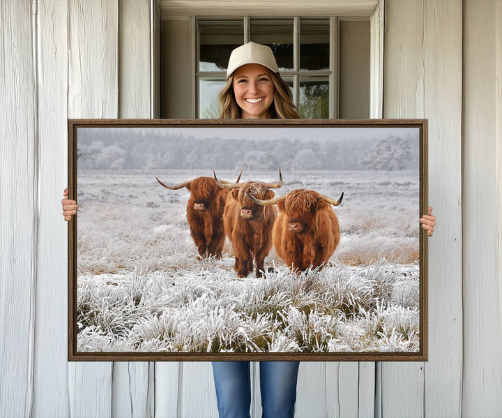 The Highland Cows in Snow canvas showcases three cattle in a frosty field.