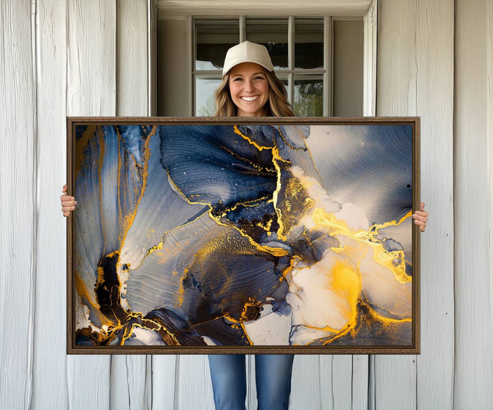 A modern luxury kitchen features a large gold and blue abstract canvas wall art print.