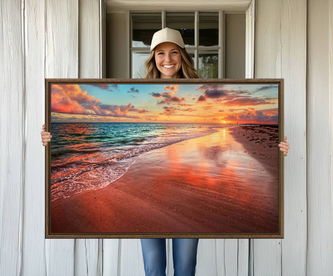 A Vibrant Sunset Beach Canvas Print with ocean waves and sandy shoreline enhances coastal-themed interiors.