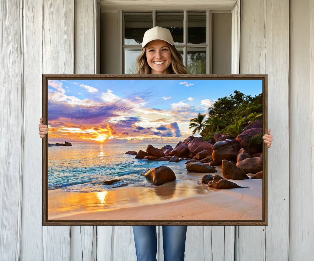 A Tropical Beach Sunset Canvas Print hangs on a wooden wall.