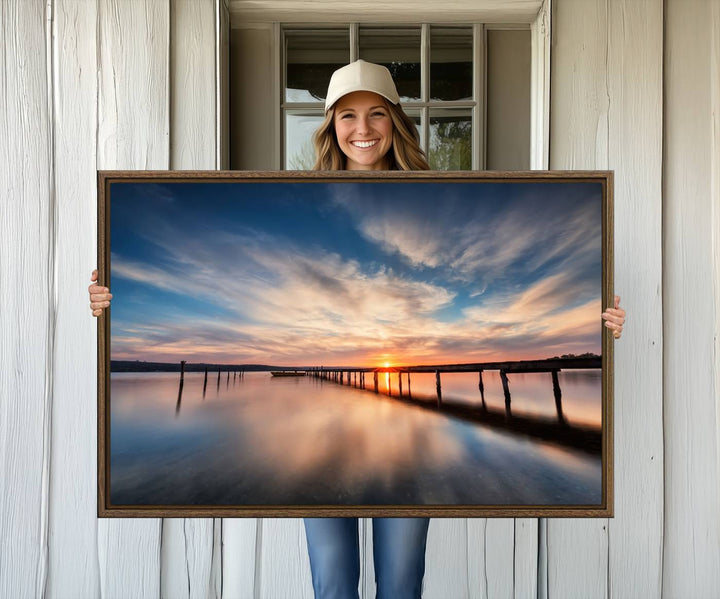 The Sunset Pier Canvas features a serene coastal landscape with vibrant hues under cloudy skies, ideal for modern decor.