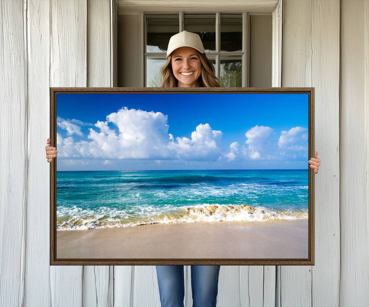 The Tropical Beach 3-Panel Canvas Wall Art features ocean waves gently lapping on a beach under blue skies, making it an ideal choice for coastal decor.