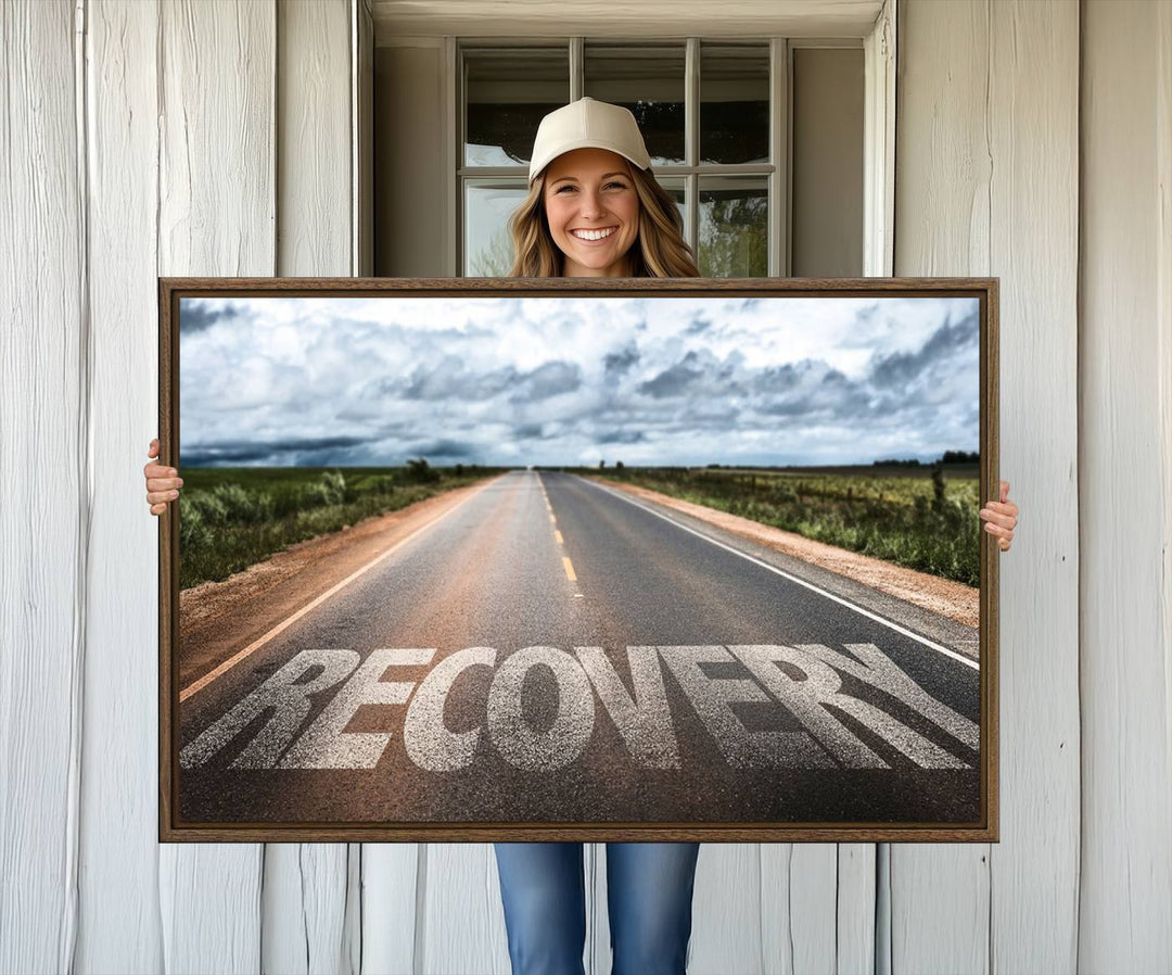 The Recovery Road Wall Art Canvas Print depicts a road under a cloudy horizon.