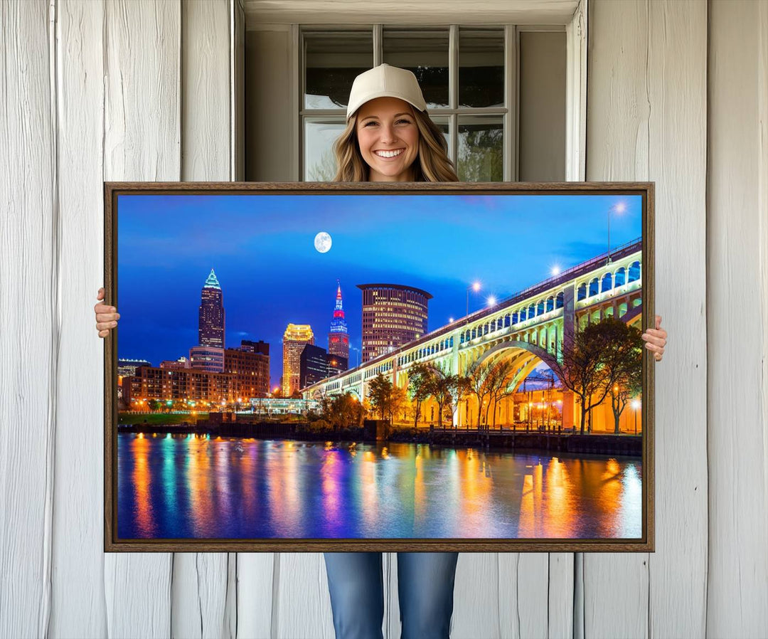 A Cleveland Night Skyline Wall Art on museum-quality canvas showcases a bridge and illuminated buildings.