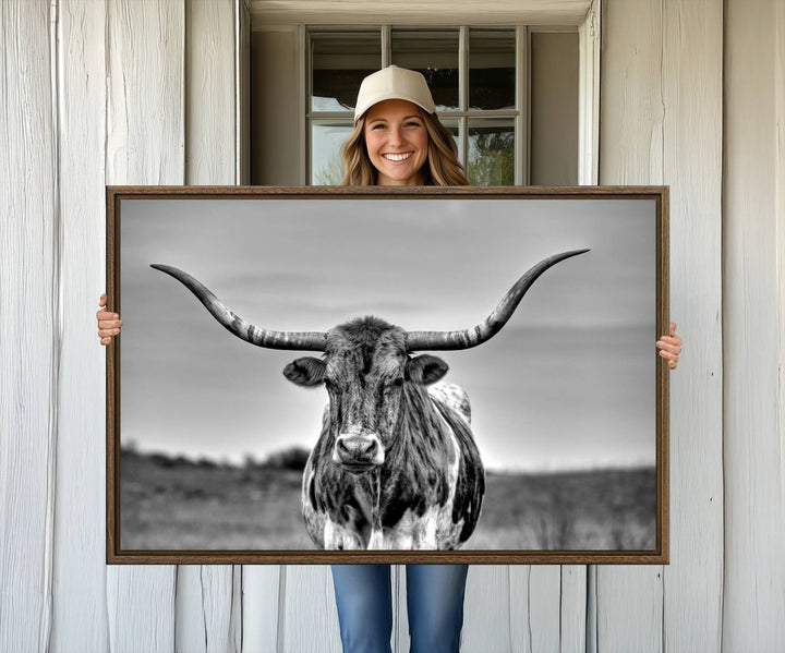 The Texas Longhorn Cow wall art, divided into three panels, is of gallery quality and displayed on a dark wall.