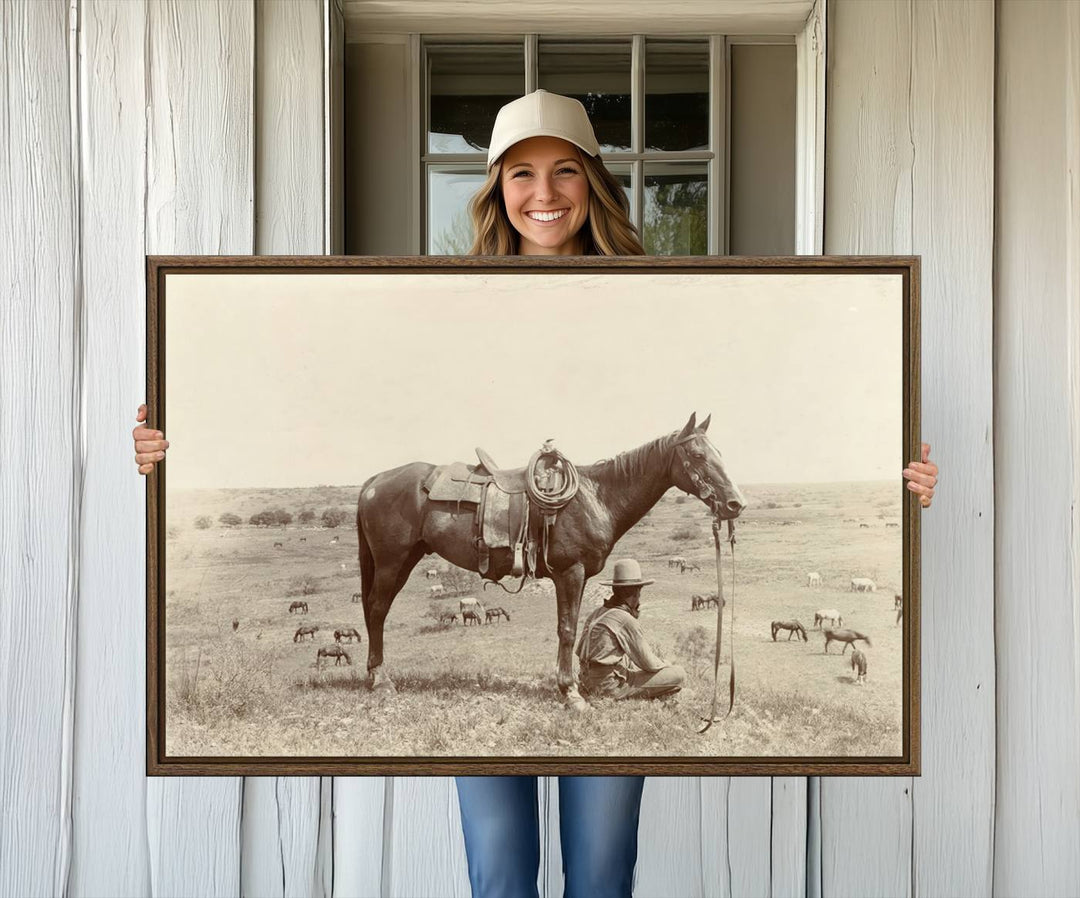 Cowboy Wall Art - Vintage Western Horse Canvas Print features a cowboy kneeling by his horse in a field.