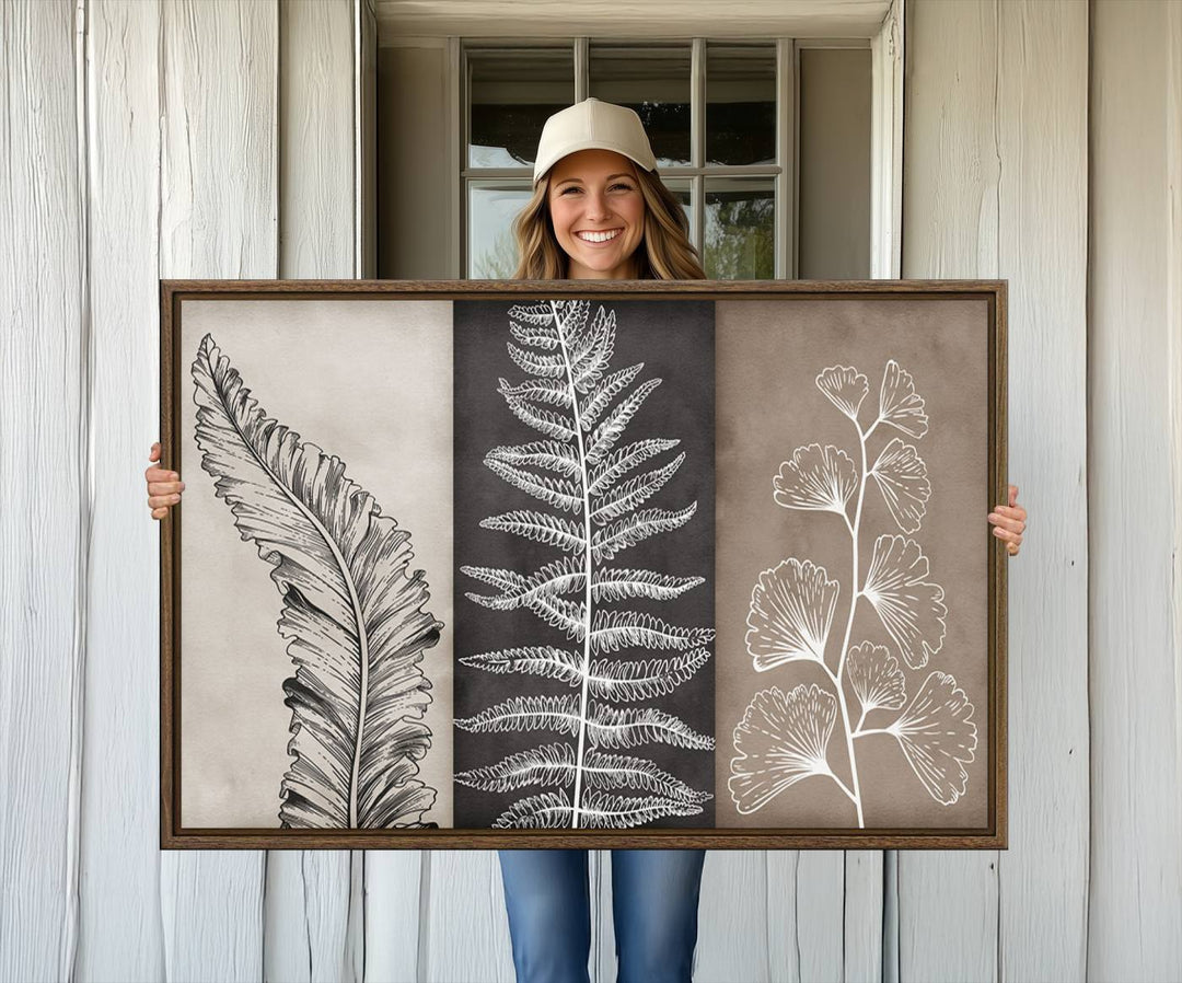 Three framed botanical wall art pieces are displayed in a bright room.