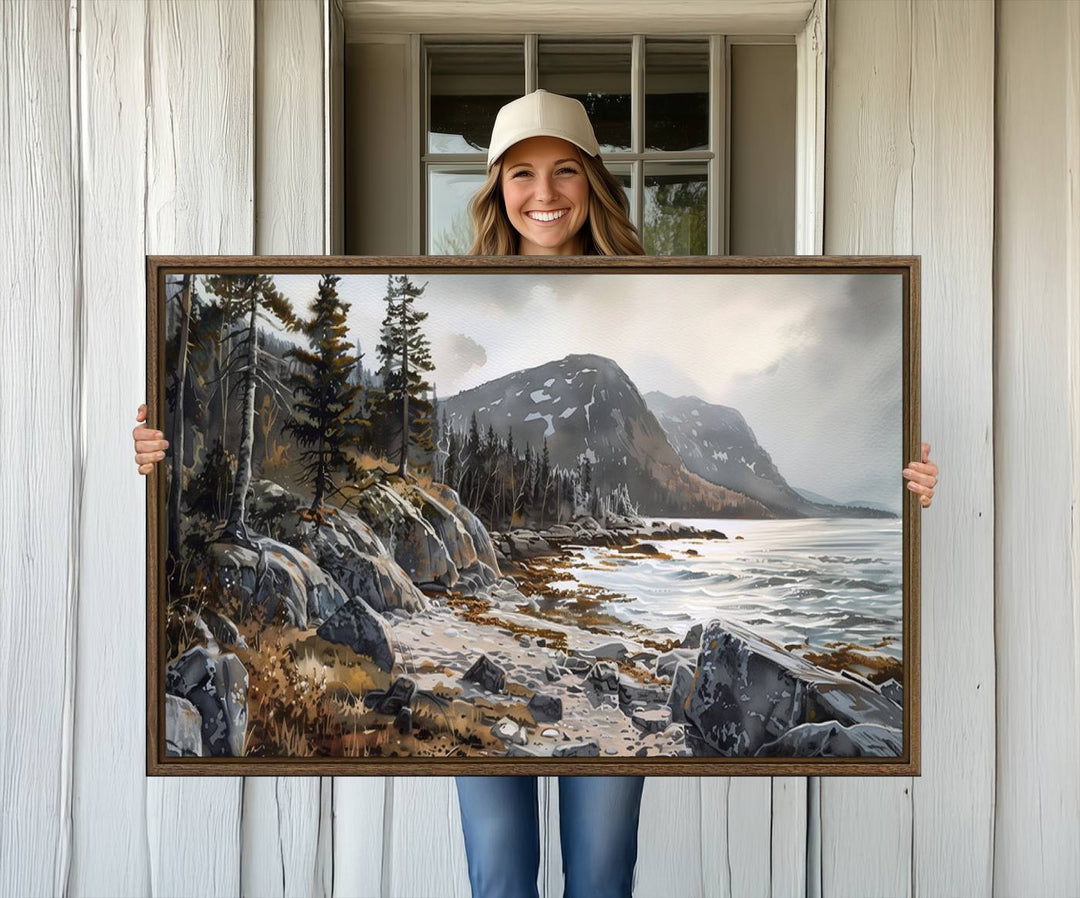 Framed wall art depicting Acadia National Parks rocky coast, trees, mountains, and sunlight over the sea; ready to hang.