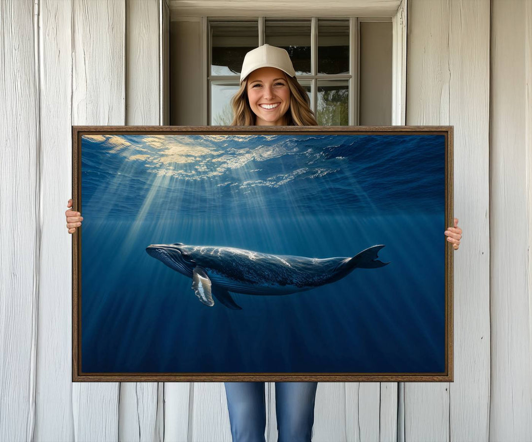 The Whale under Ocean wall art canvas print graces the white wall.