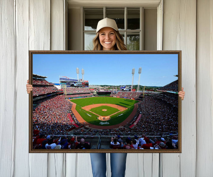 The Cincinnati Reds Baseball Team print of Great American Ball Park Stadium adorns the wall.