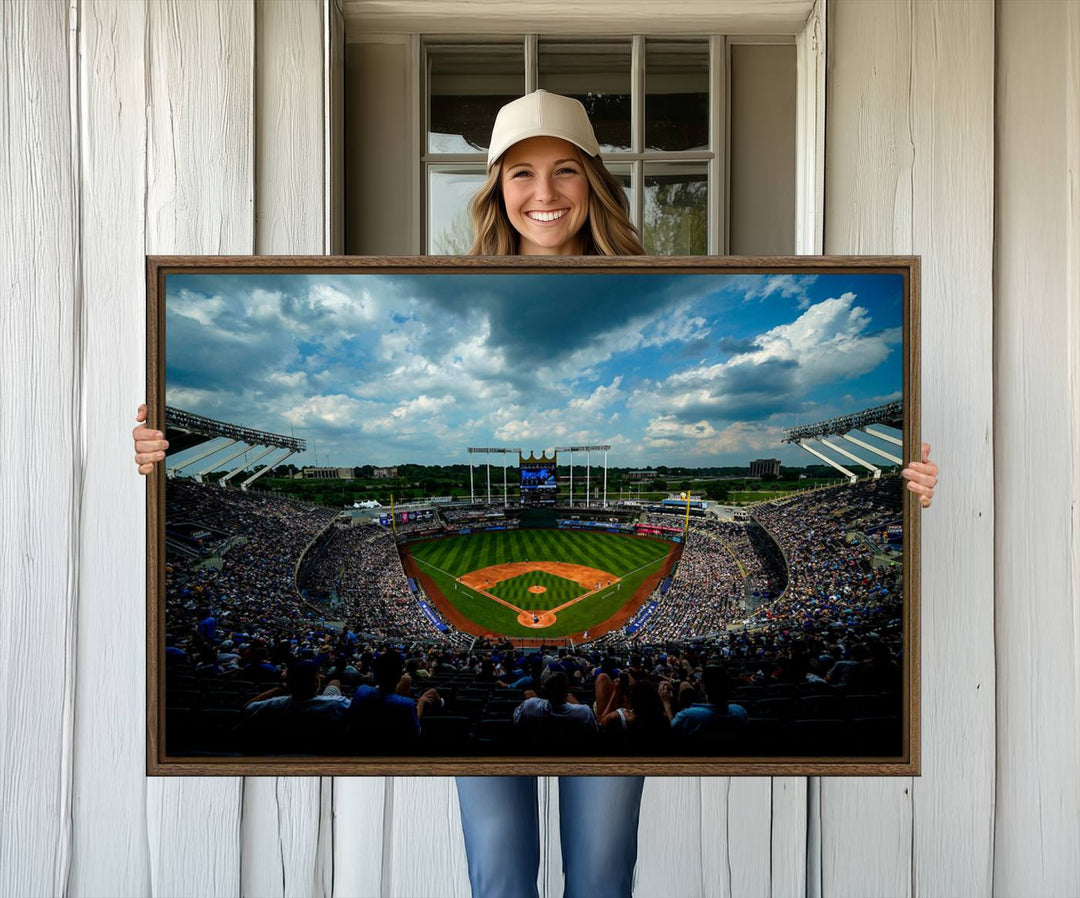 A 3-panel print of Kauffman Stadium, showcasing a crowded baseball field under cloudy skies.