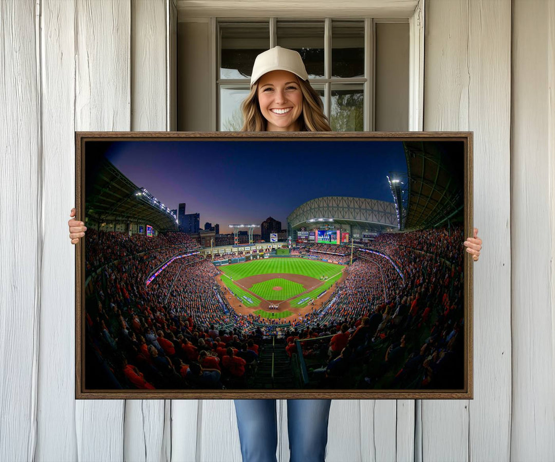 A canvas print of Houston Minute Maid Park at dusk is mounted on the wall.