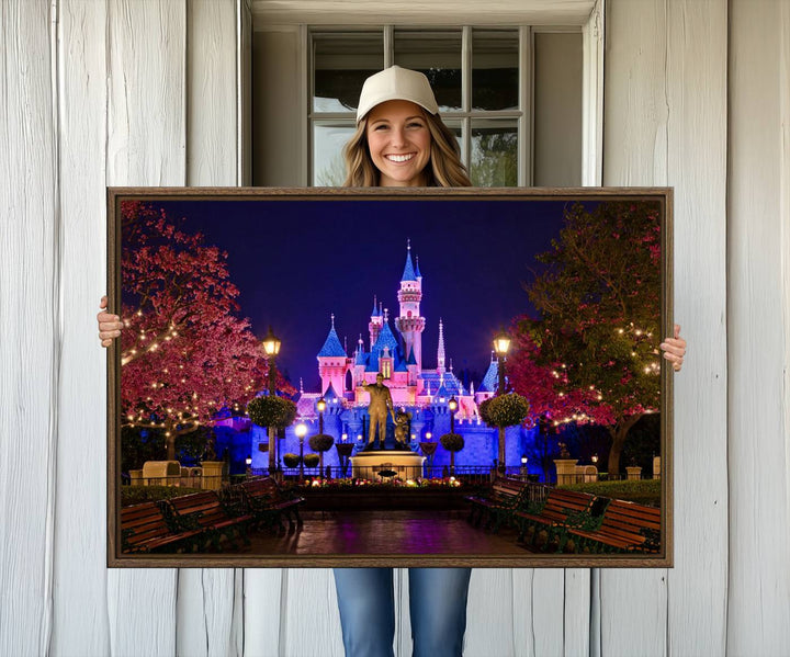 The Castle Large Wall Art is surrounded by illuminated trees at night.