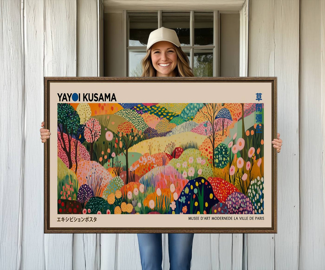 A framed Yayoi Kusama Wall Art Canvas Print features a vibrant abstract landscape adorned with flowers.