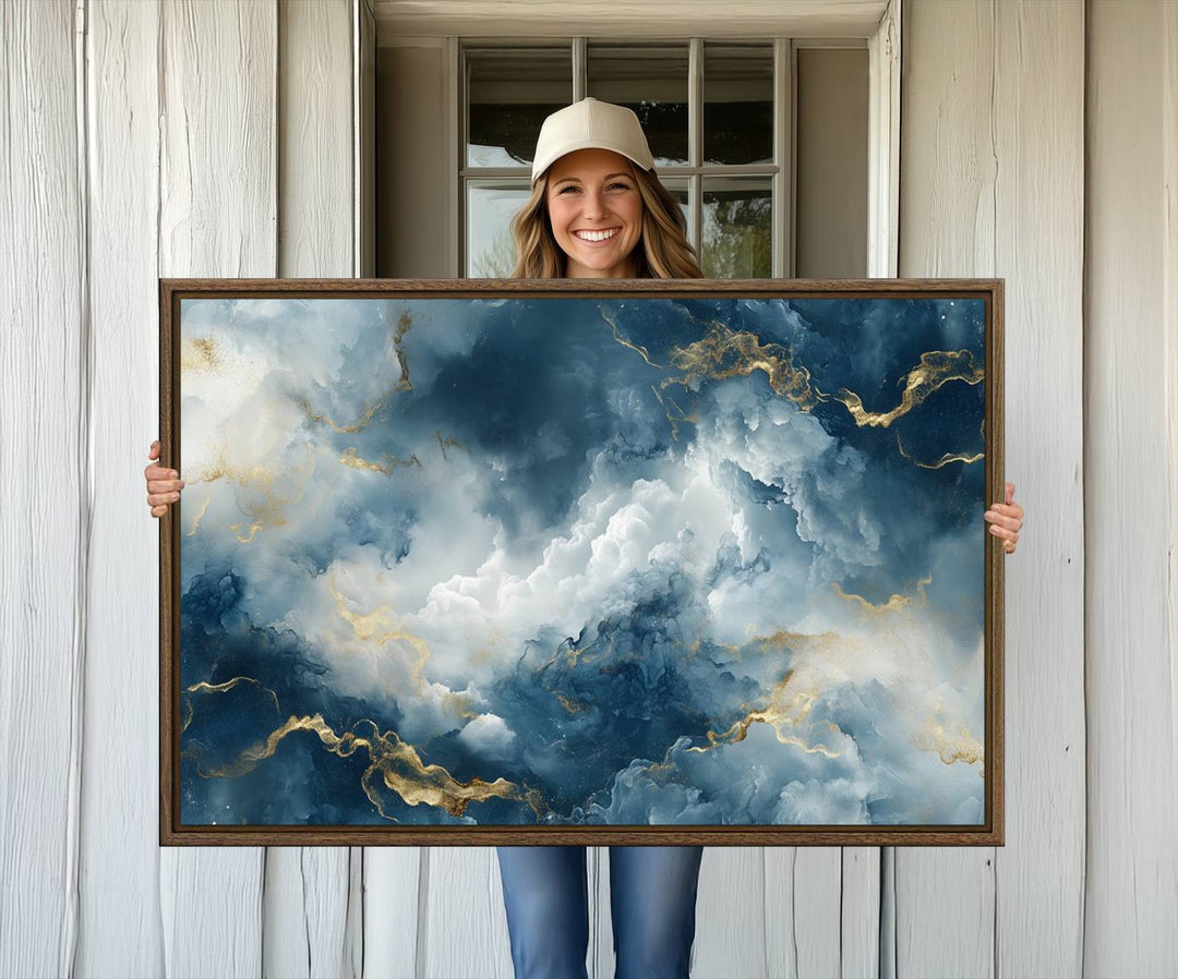 The "Large Abstract Print - Luxe Blue and Gold Abstract Canvas Wall Art" features a bold cloudscape design with swirling white patterns, ideal for modern home decor in living rooms or offices.