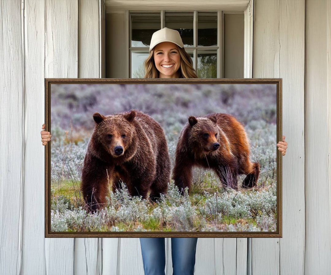 The "Queen of the Tetons" is a stunning canvas art print featuring Grizzly 399 and two bears strolling through a grassy field. Its gallery-quality finish beautifully captures the essence of nature, making it perfect for rustic home decor.