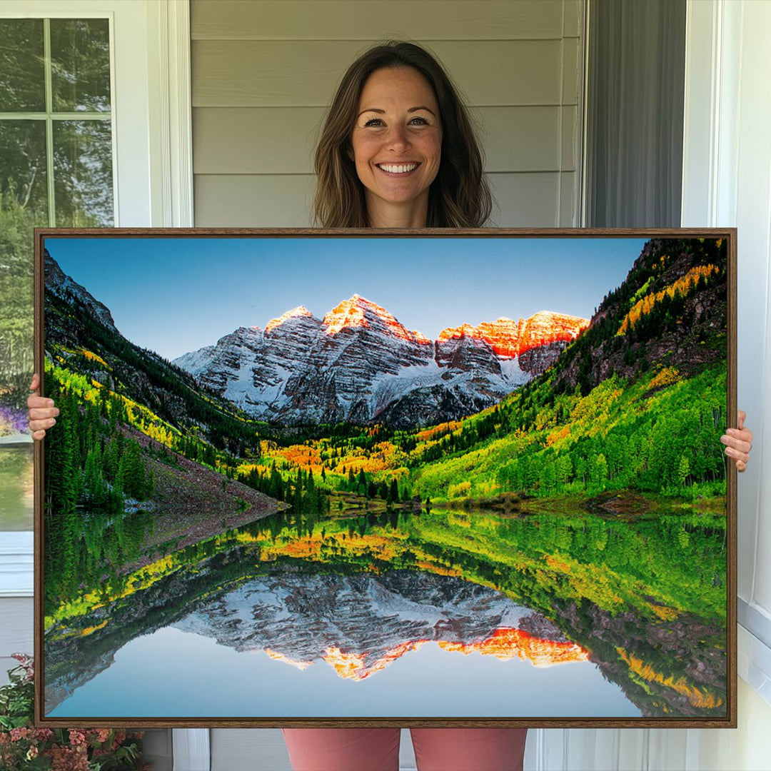 The Sunrise Maroon Bells Lake Wall Art Print beautifully captures North Maroon Peak mirrored in the tranquil lake, framed by lush greenery.