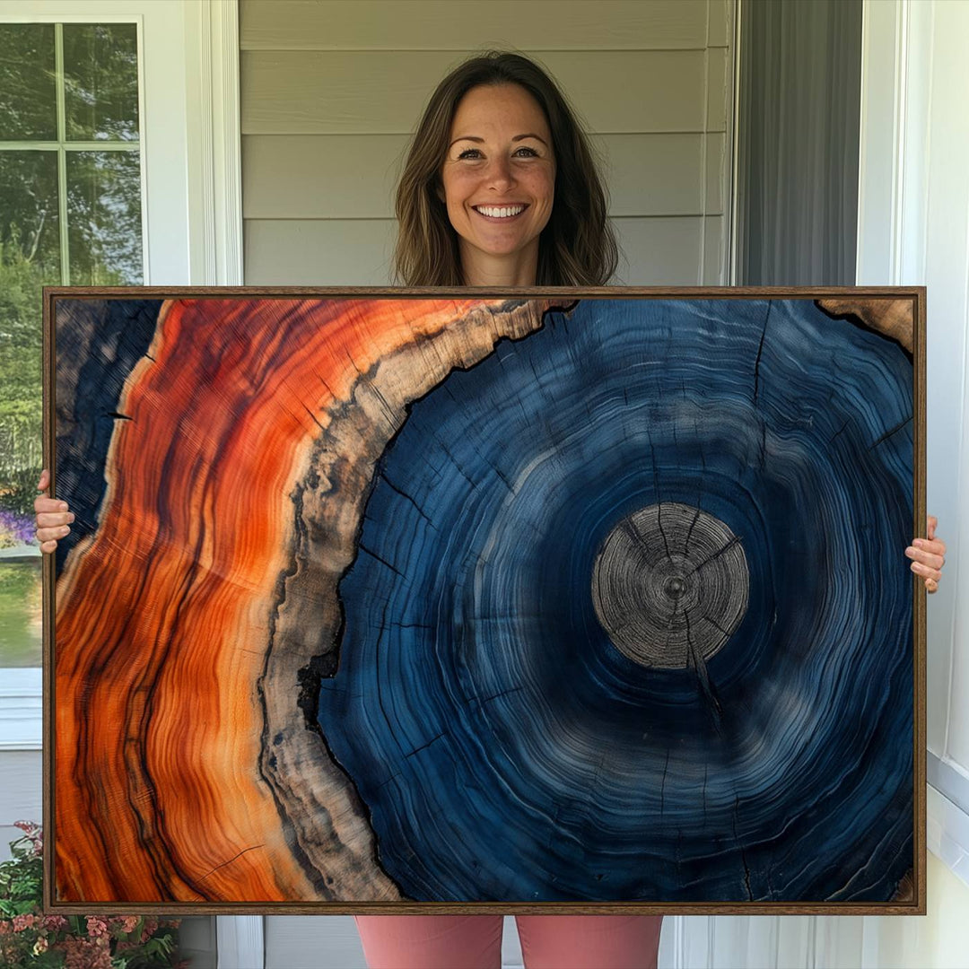 Abstract Tree Ring Wall Art Print on canvas featuring vibrant blue, orange, and brown rings with a natural rustic wood texture. Free shipping available!.