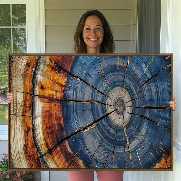 Close-up of blue, brown, and orange wood grain rings on the Abstract Tree Rings Canvas Wall Art Print.