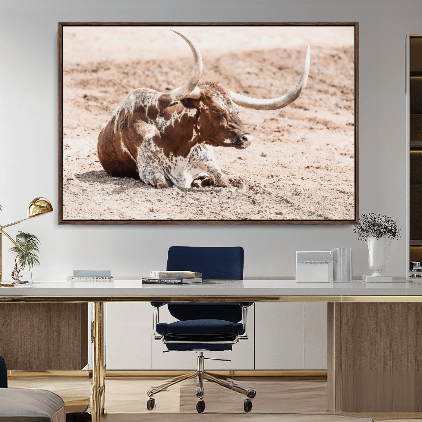 Texas Longhorn bull resting on dusty ground with warm tones, ideal for rustic western or farmhouse-themed wall decor.