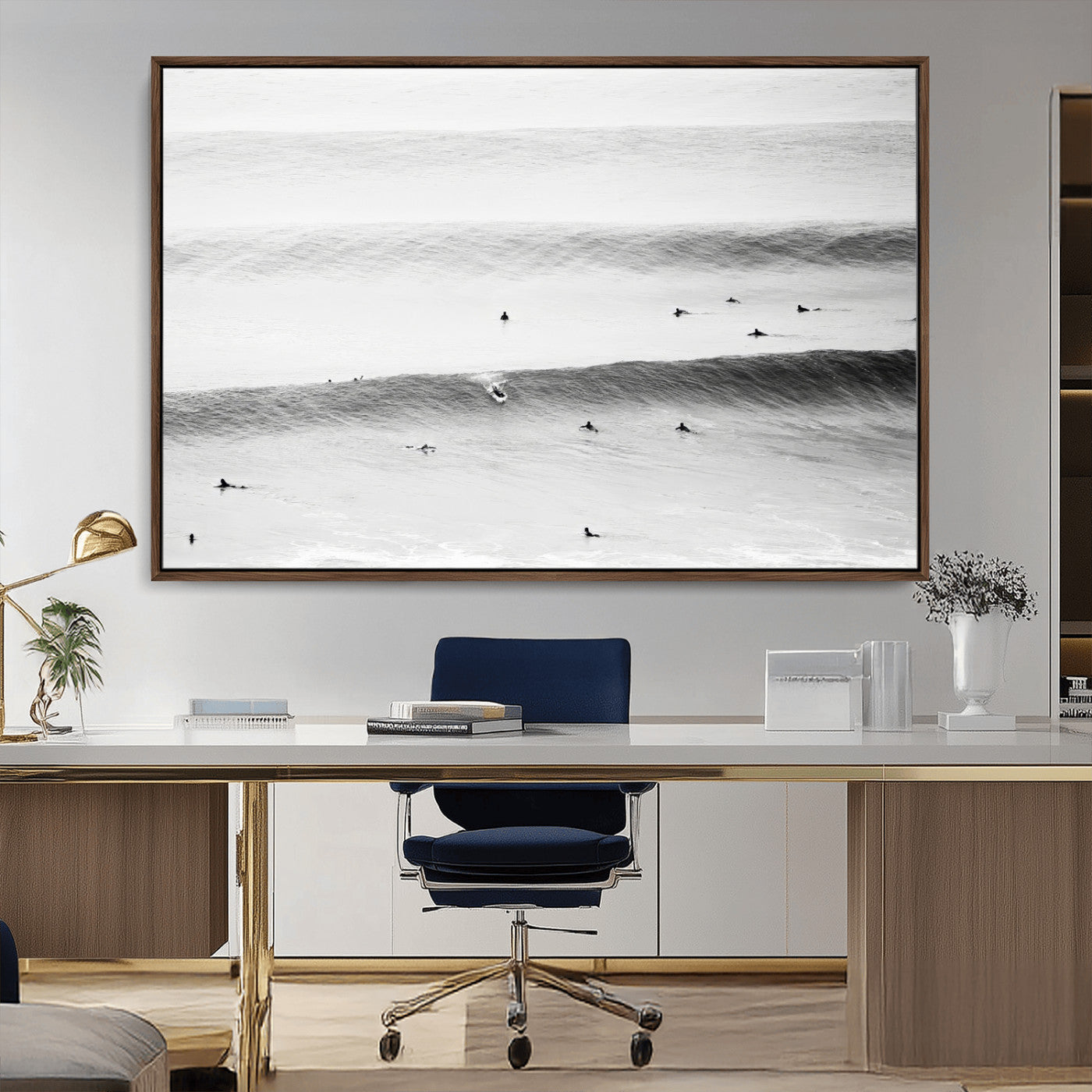 A monochrome photograph of swimmers gliding through gentle ocean waves, evoking a sense of calm and movement.