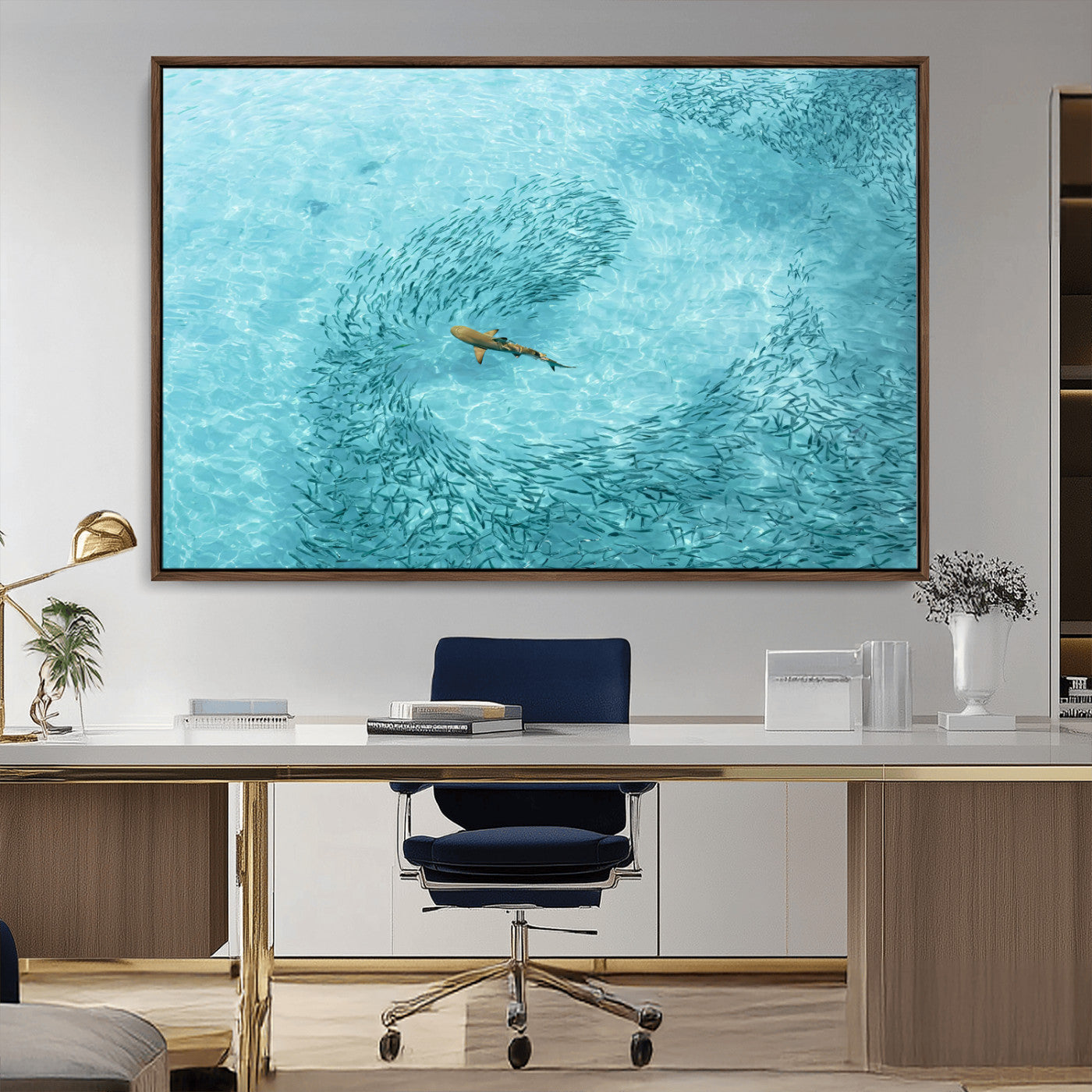 Aerial view of a shark swimming through a swirl of fish in clear turquoise waters, perfect for calm coastal or beach house decor.