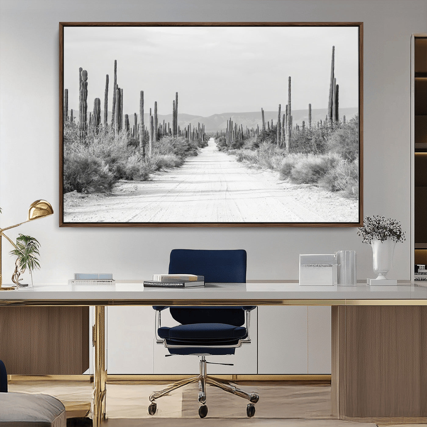 A black and white desert road stretching through a cactus-filled landscape, creating a rugged and timeless southwestern aesthetic with a sense of adventure.