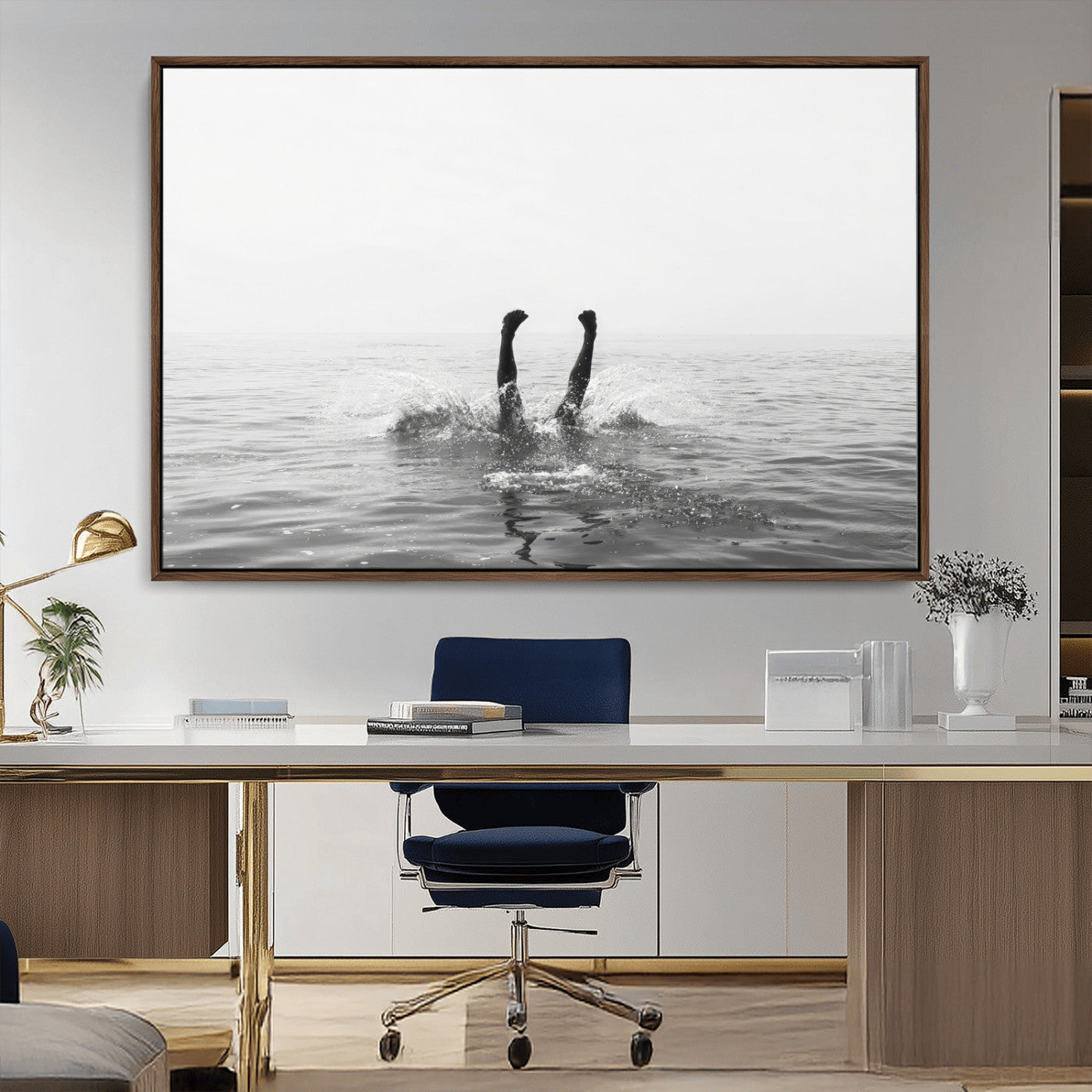 A black and white minimalist water scene capturing a playful splash as a swimmer dives upside down, creating a carefree and artistic aquatic aesthetic.