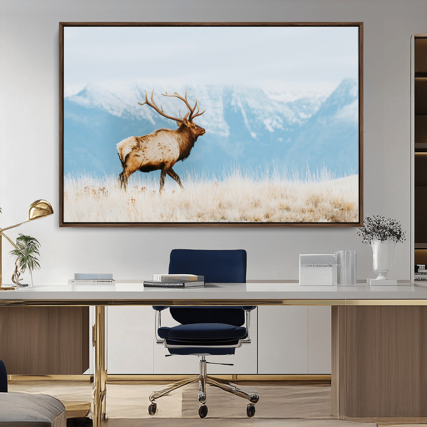 Majestic elk with antlers walking on golden grass, snowy mountains behind, perfect for rustic lodge or Scandinavian decor.
