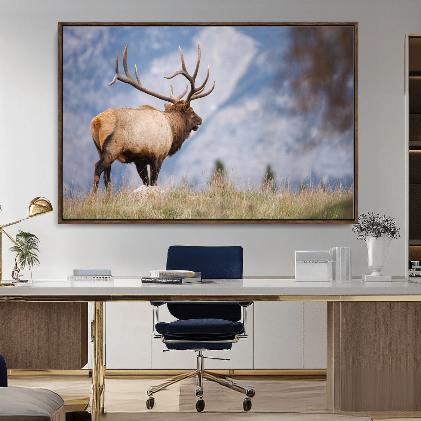 Elk with antlers standing on grass with mountain background, ideal for rustic, cabin, or lodge-inspired wall decor.