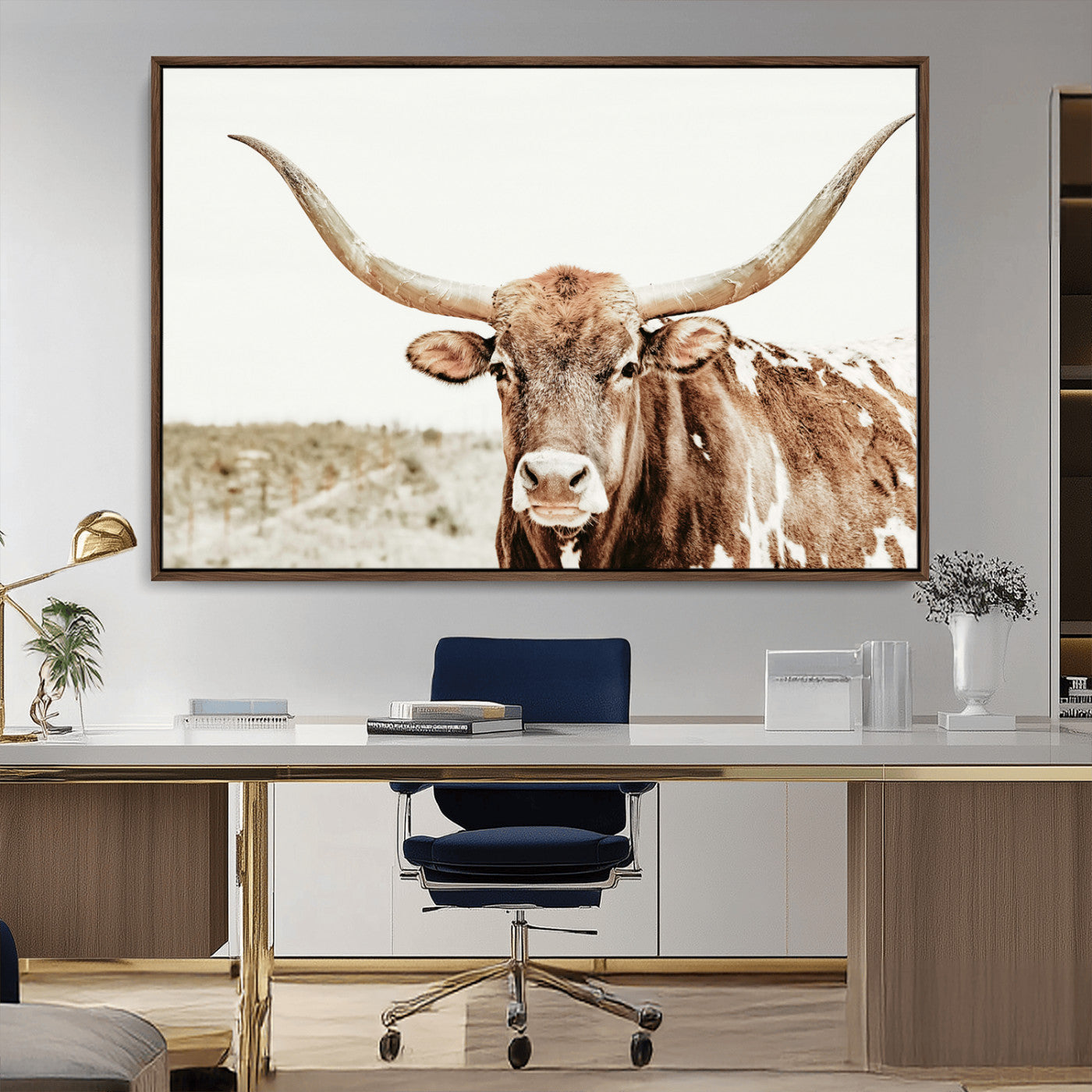 A Texas longhorn bull with wide horns, standing in a dry field under soft light, ideal for rustic farmhouse or western-themed interiors.