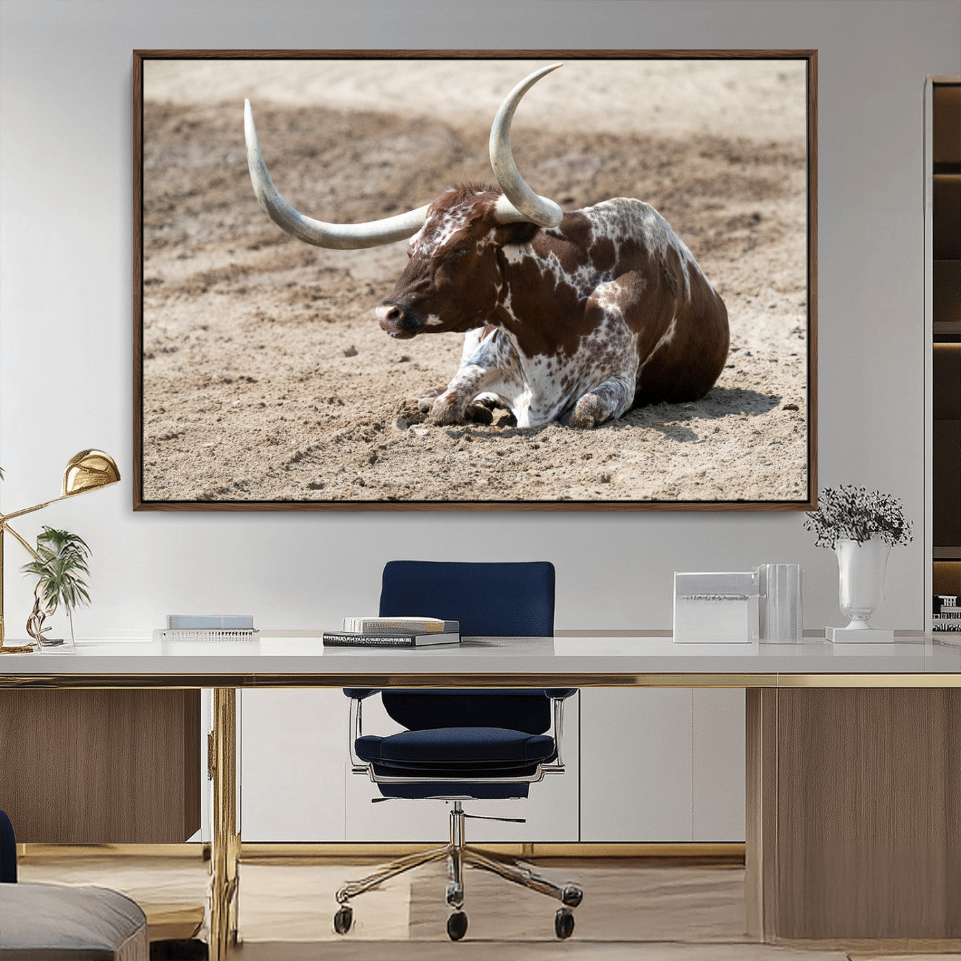 Texas Longhorn resting on sandy ground with large curved horns, capturing a rustic Western aesthetic perfect for farmhouse-style wall art.