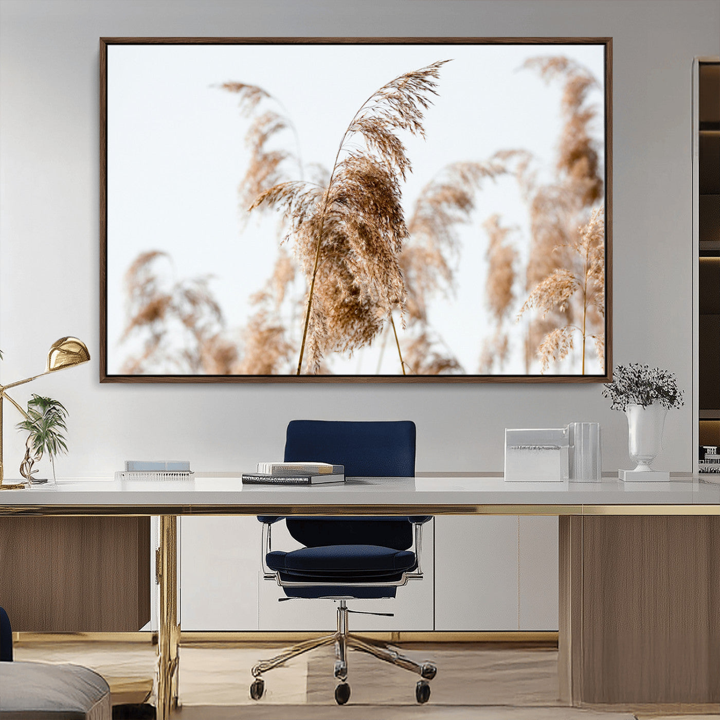 Close-up of pampas grass swaying in the wind against a soft white sky, creating a neutral and minimalist botanical aesthetic.