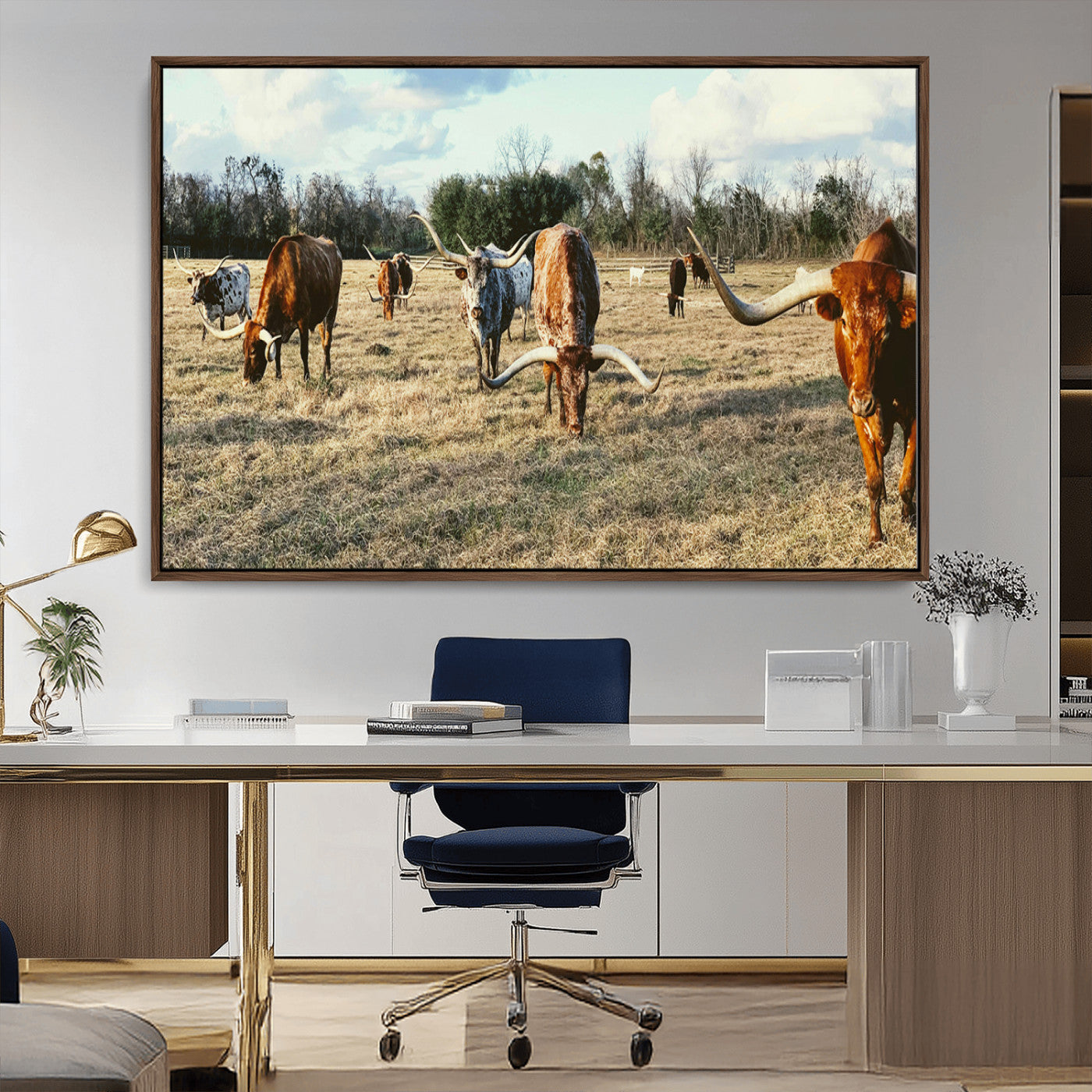 A herd of Texas Longhorn cattle grazing in an open field under a partly cloudy sky, capturing a rustic and Western ranch aesthetic.