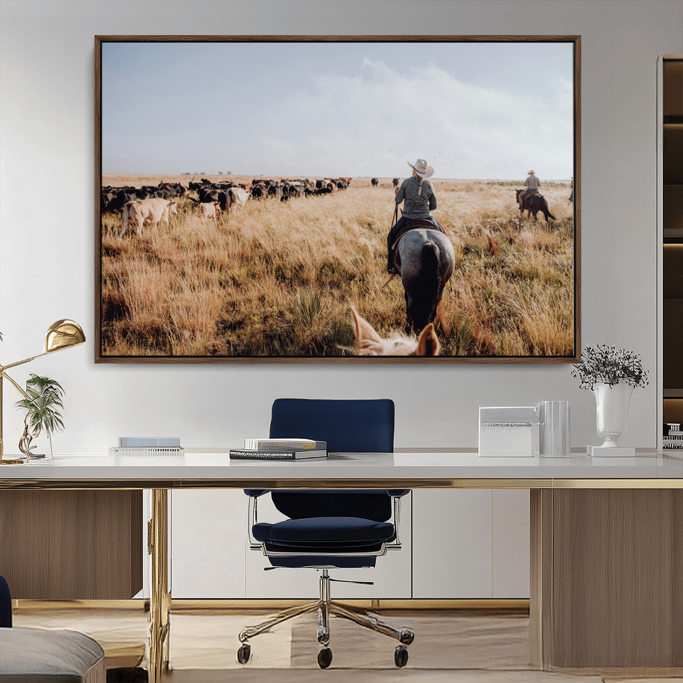 A cowboy and cowgirl on horseback herding cattle through golden grasslands, capturing a rustic and authentic Western ranch lifestyle.