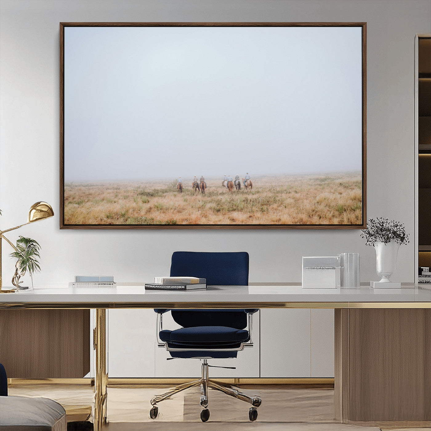 A group of horseback riders moving through a fog-shrouded field, evoking a calm Western scene with golden grasses and soft horizons.