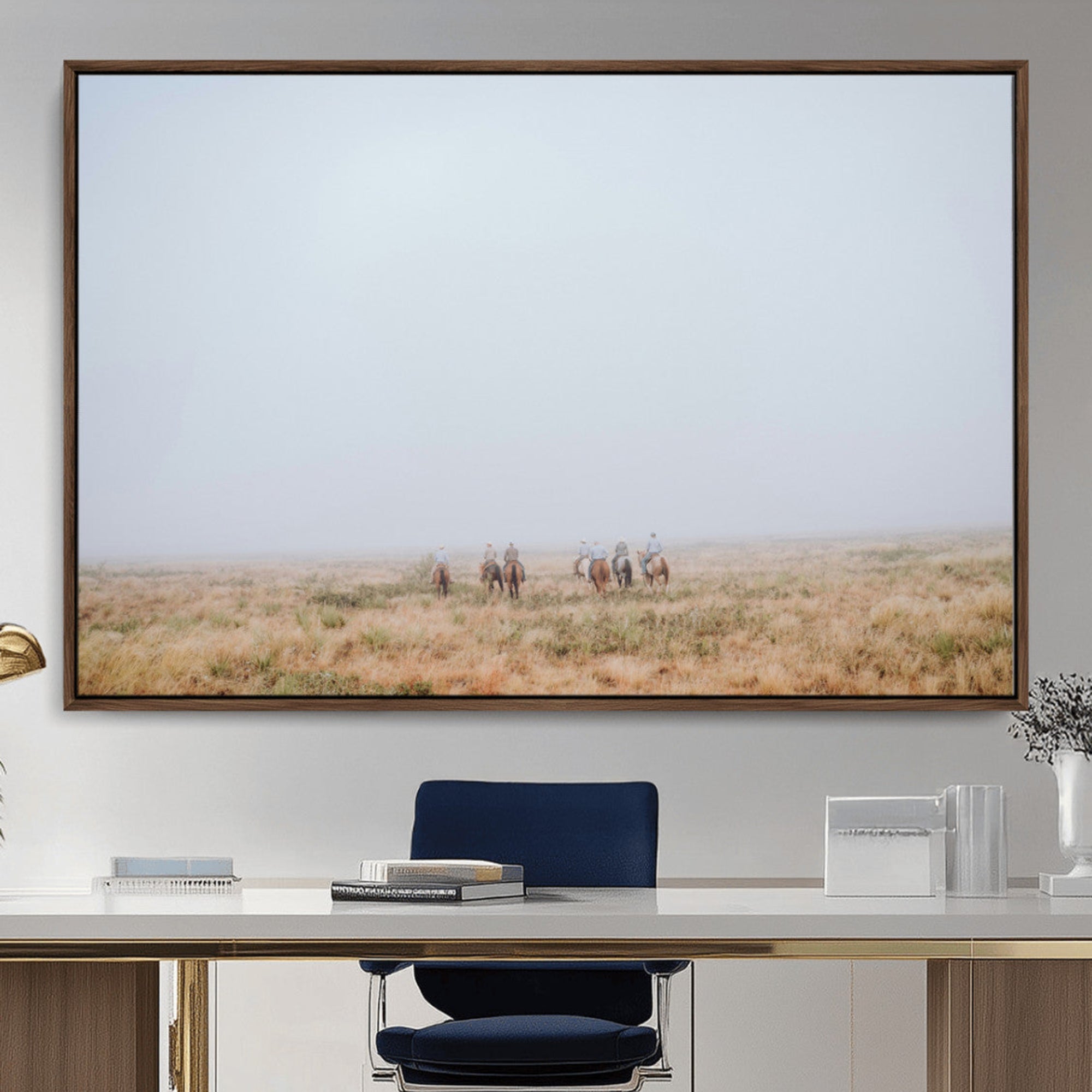 A group of horseback riders moving through a fog-shrouded field, evoking a calm Western scene with golden grasses and soft horizons.