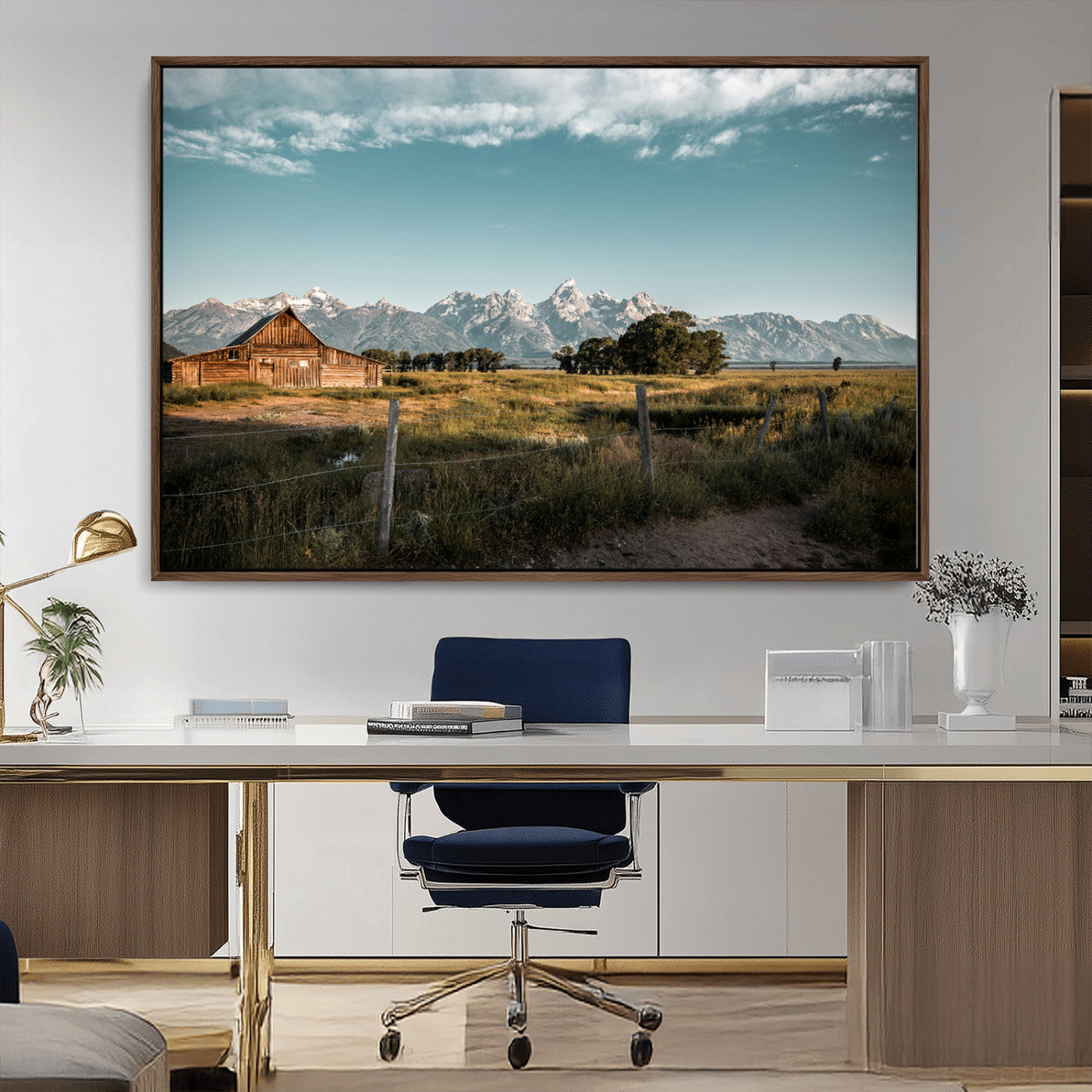 A rustic farmhouse with a wooden barn set against majestic mountain peaks under a soft blue sky, evoking peaceful countryside charm.