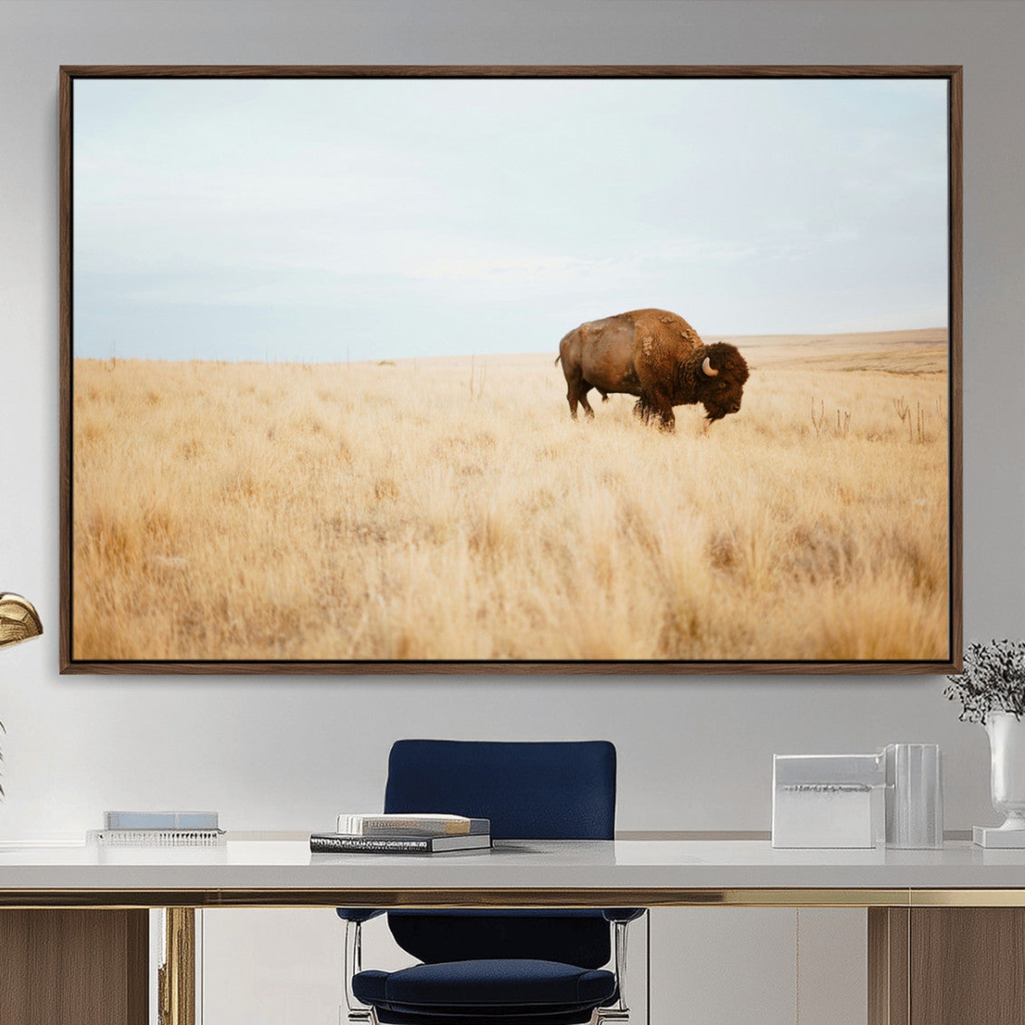 A lone bison standing in a vast golden grassland under a soft blue sky, evoking a rustic and Western aesthetic, ideal for farmhouse decor.