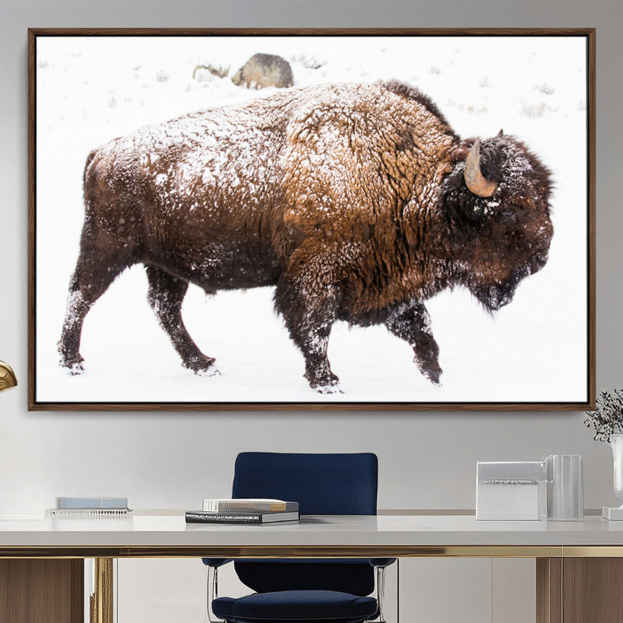 Side profile of a powerful bison walking through deep snow, with frost-covered fur and a white winter background, perfect for rustic and western decor.
