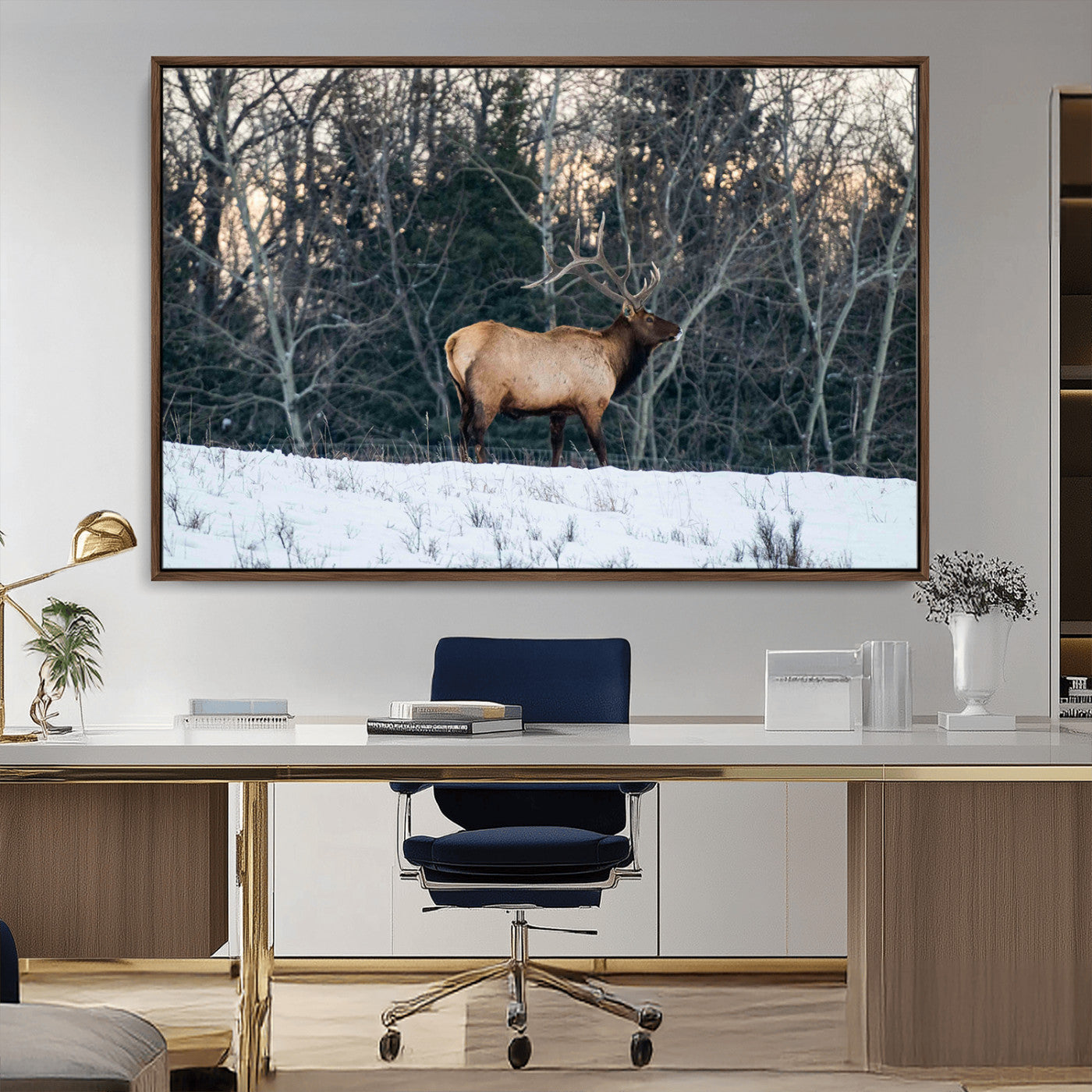 A majestic elk with large antlers standing in a snowy field against a winter forest backdrop, perfect for rustic and wildlife-themed home decor.