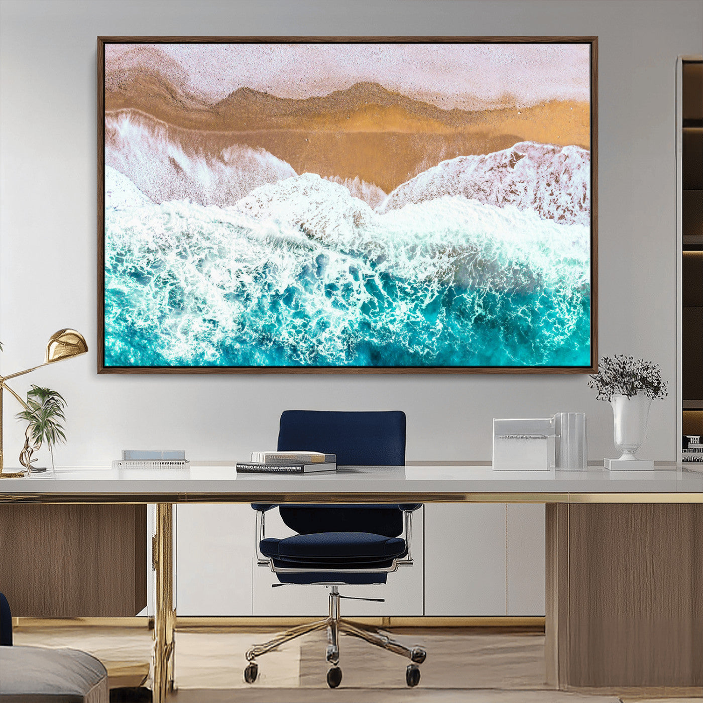 Aerial view of ocean waves crashing onto a sandy beach, with turquoise water and foamy white surf, creating a serene coastal aesthetic for home decor.